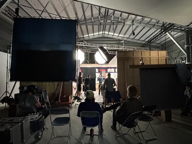Crew behind the camera on a working day inside the stage