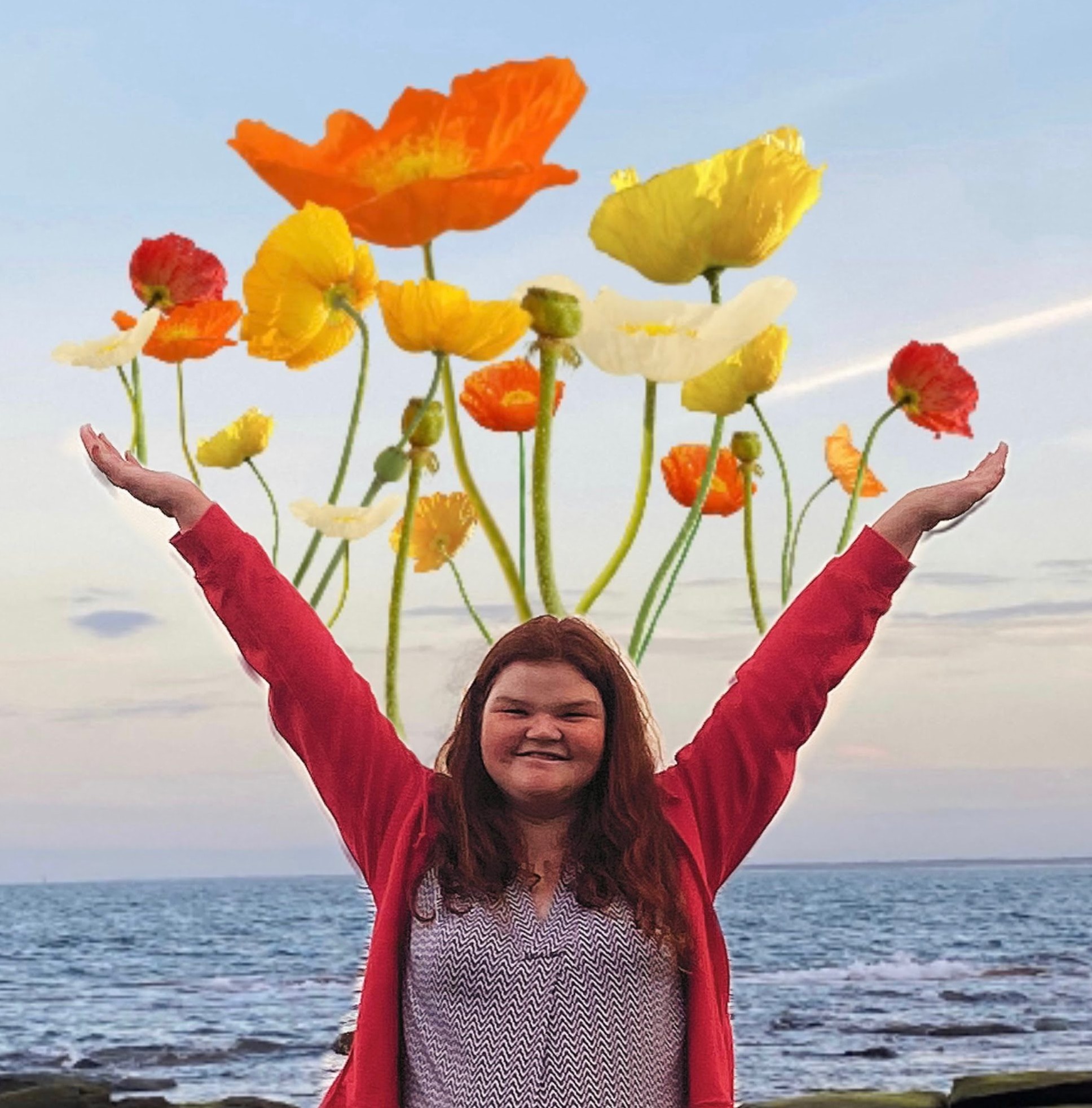 A PeerWave participant celebrating by the sea, arms raised amongst bright poppies