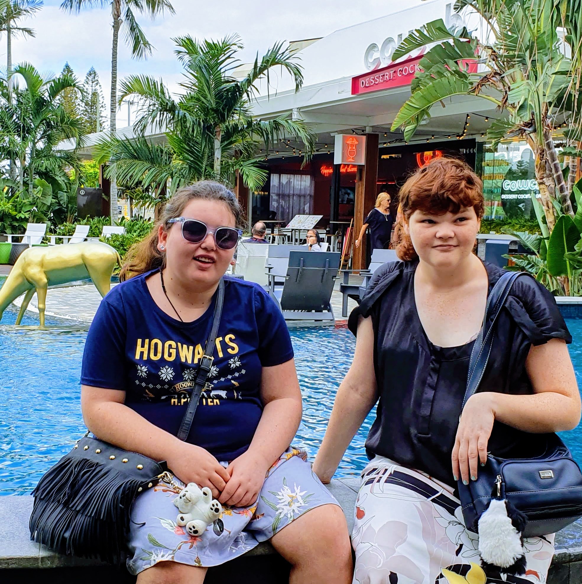 Two PeerWave participants enjoying a bright day out by the pool