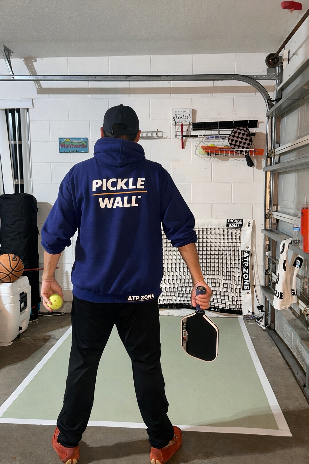 Player training with Pickle Wall pro net and kitchen lines in a home garage