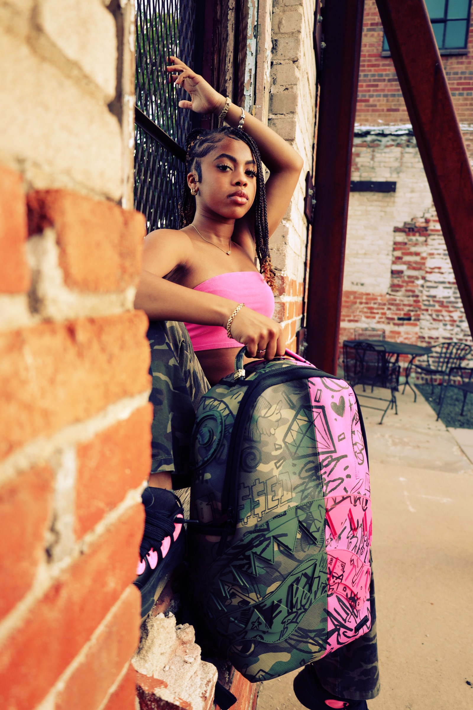 Pink top in a graffiti alley