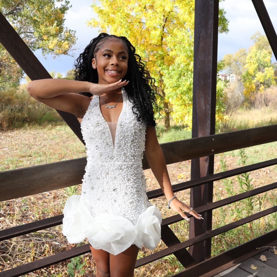 Senior in pearl dress under fall leaves