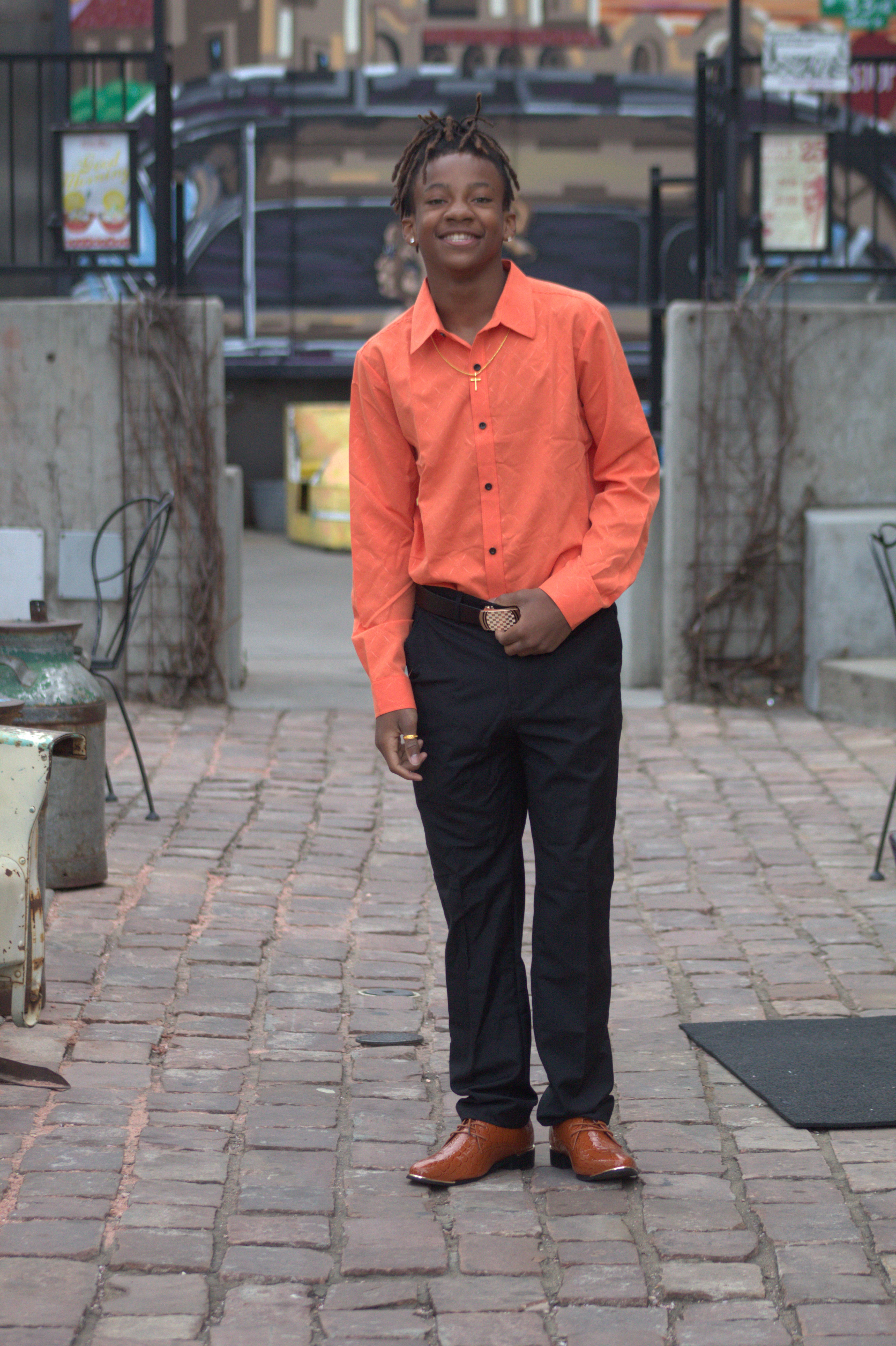 HOCO portrait in orange shirt downtown