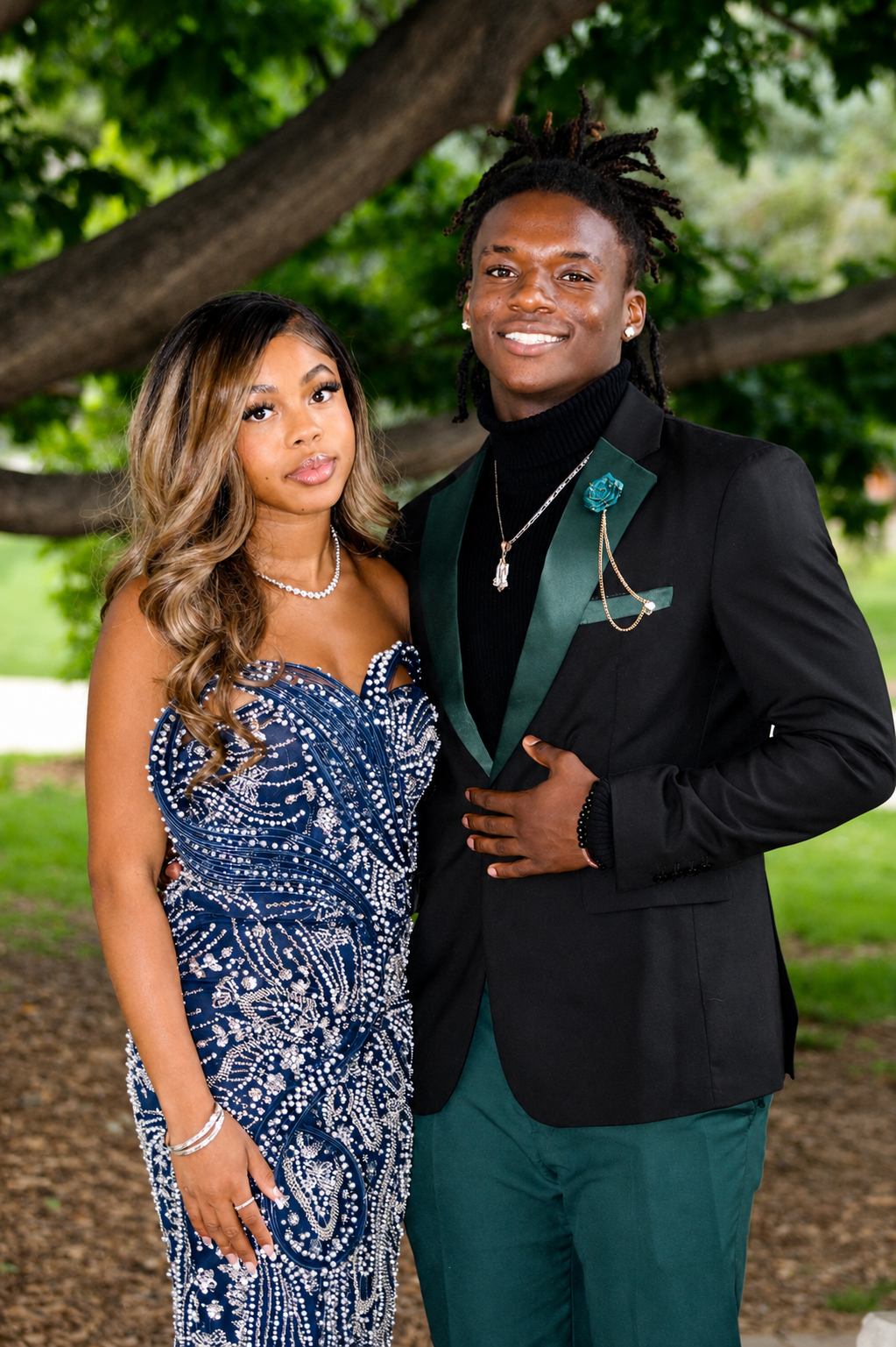 Senior prom couple · navy sequin gown & emerald tux under the tree