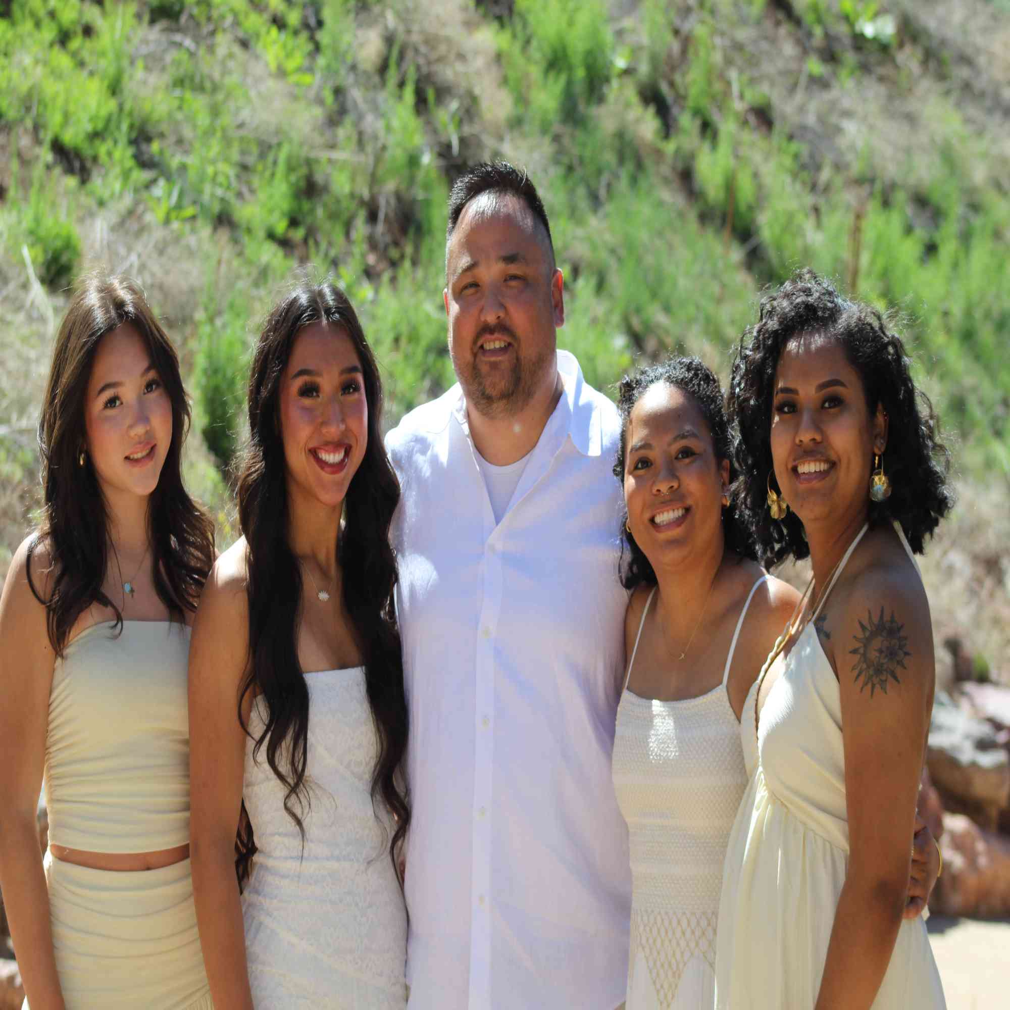 Dad with his four daughters in cream by the canyon