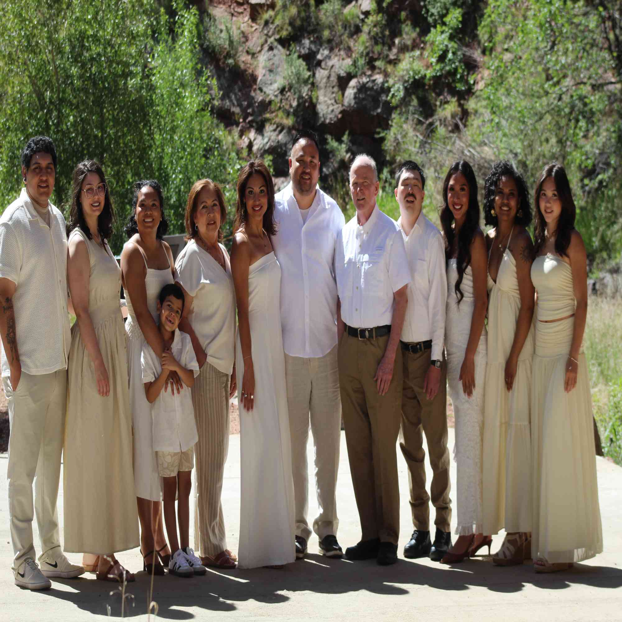 Extended family of twelve in cream — three generations together