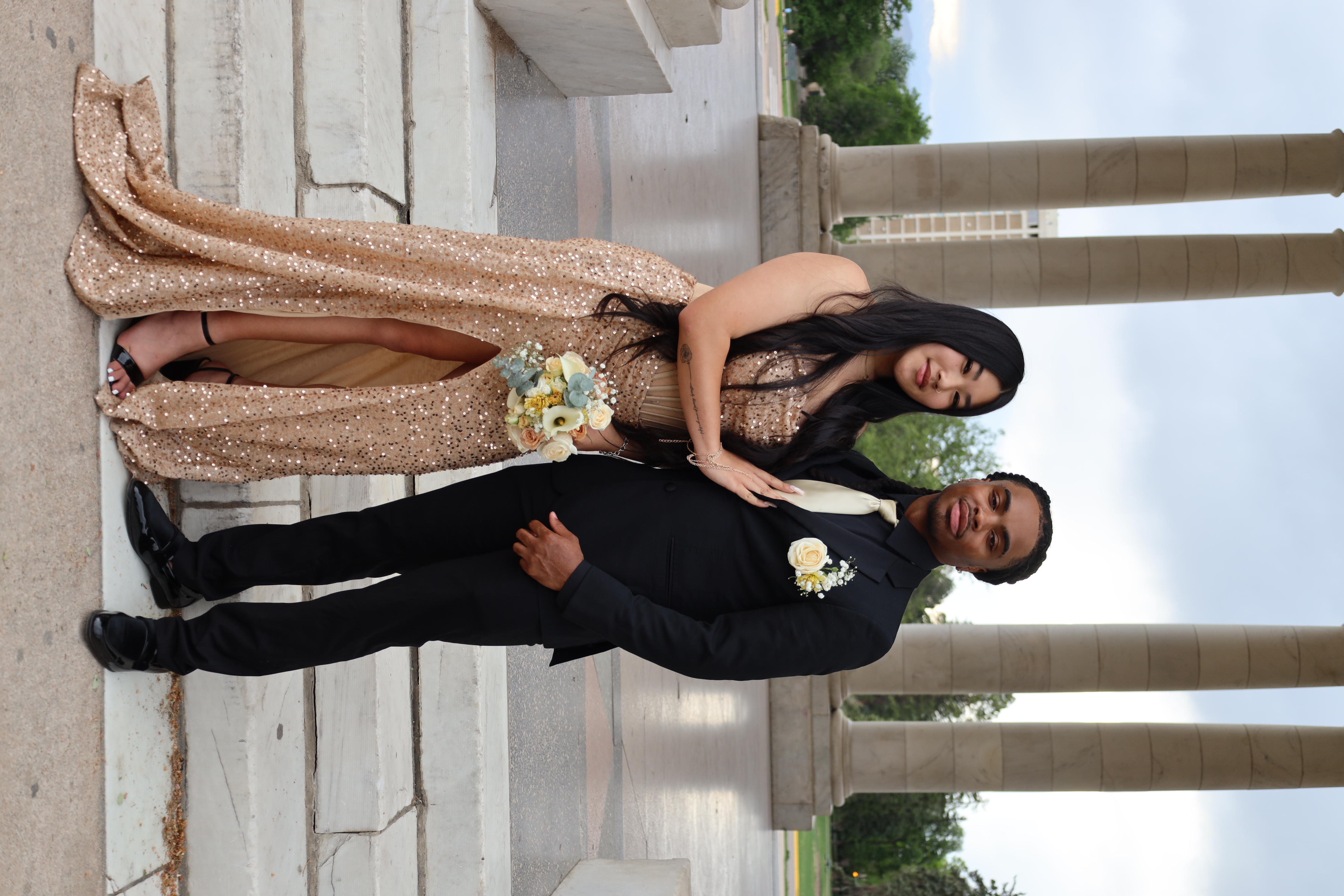 Senior prom couple · champagne sequins & black tux at the columns