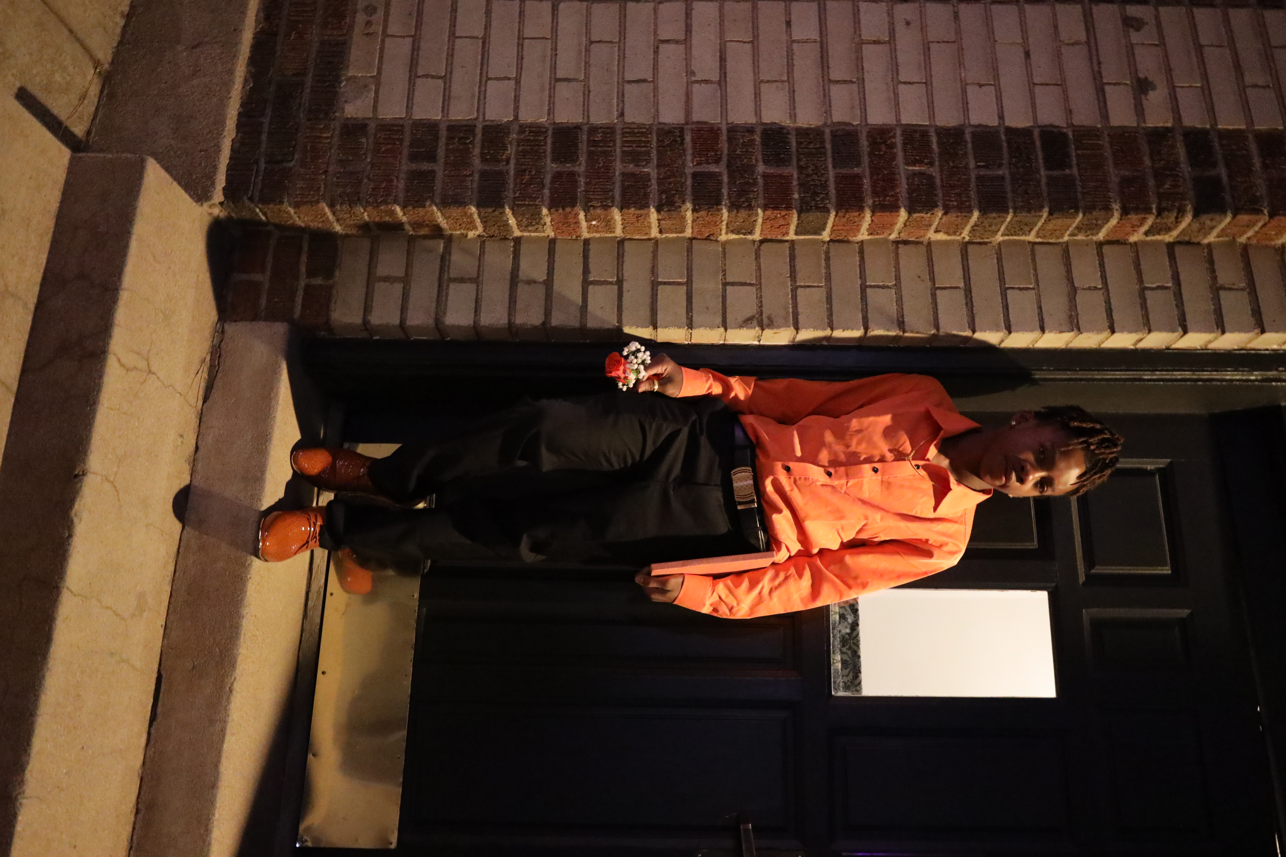HOCO portrait in orange shirt on the steps