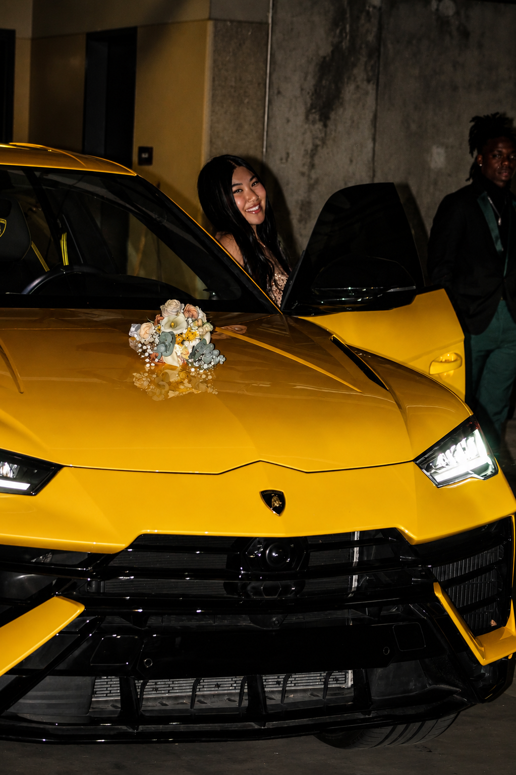 Prom arrival · smiling over yellow Lamborghini hood with bouquet