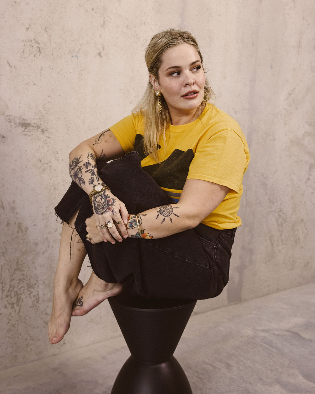 Editorial — yellow tee, denim, tattoos