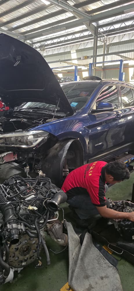 BMW X5 vehicle on hoist during repair