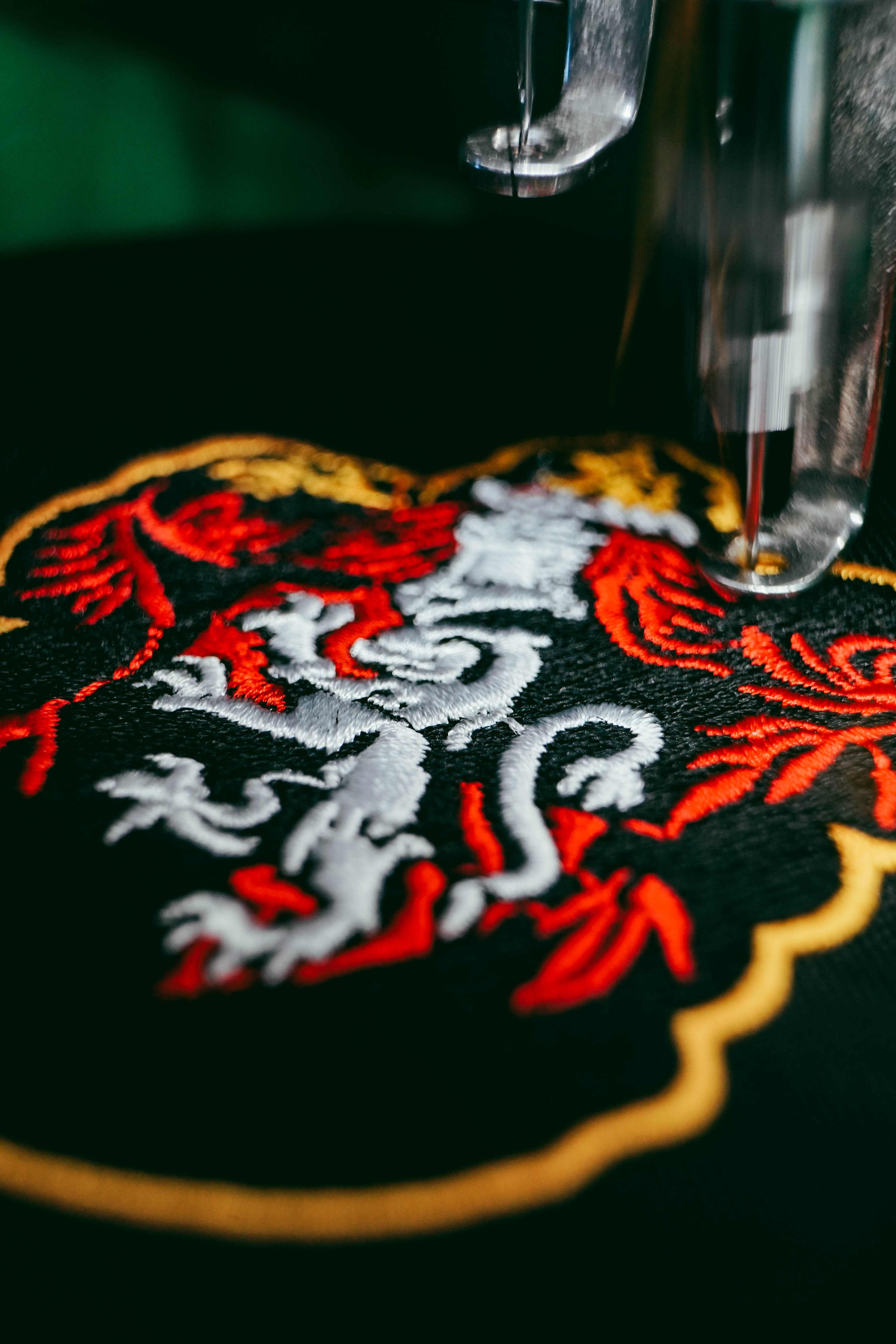 Close-up of crisp multi-color embroidery on dark fabric — Burda Pinas