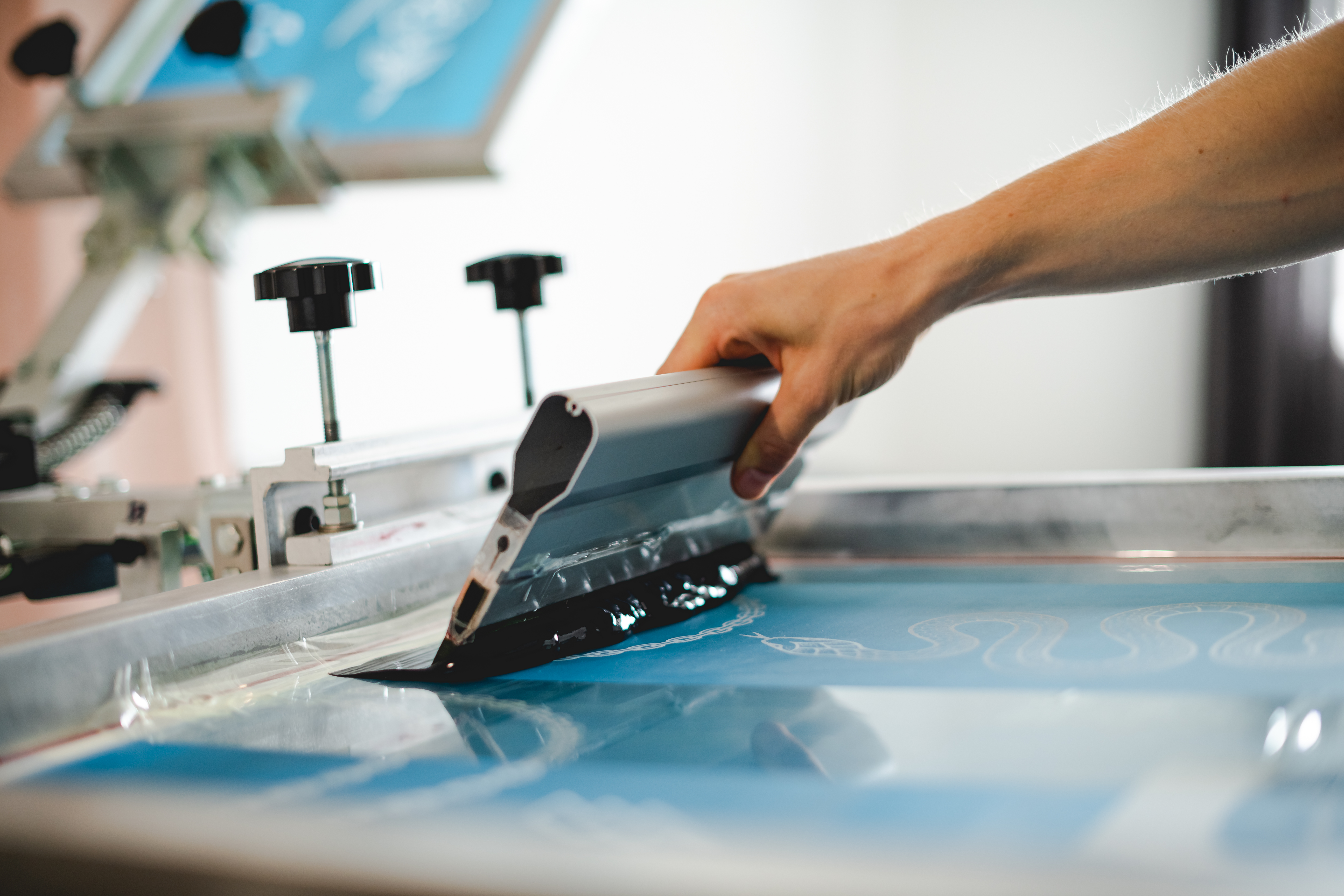 Live merch printing activation at Rhyme Fest LA Kulture Market — Pusha Teez festival booth with on-site screen printing