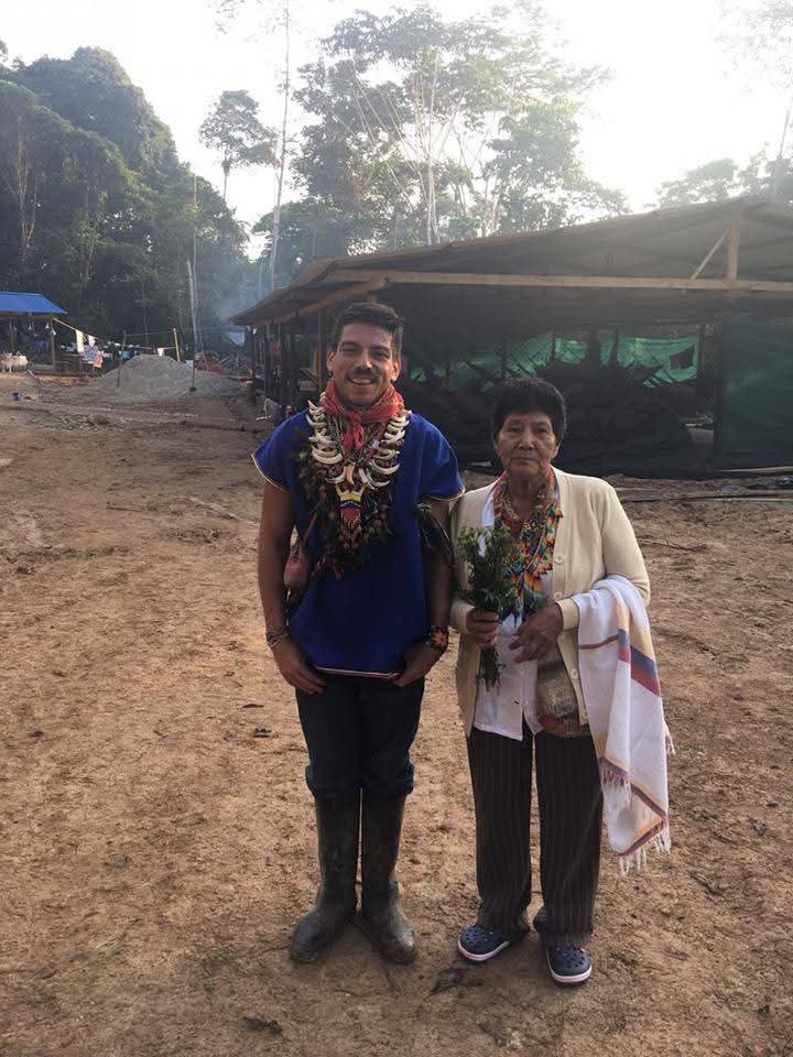 Gabriel Guillén beside an Indigenous elder grandmother in the Amazon at sunrise, after ceremony