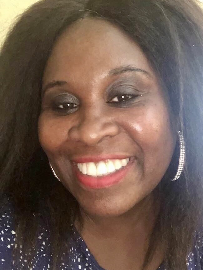 Coach Glenda smiling warmly