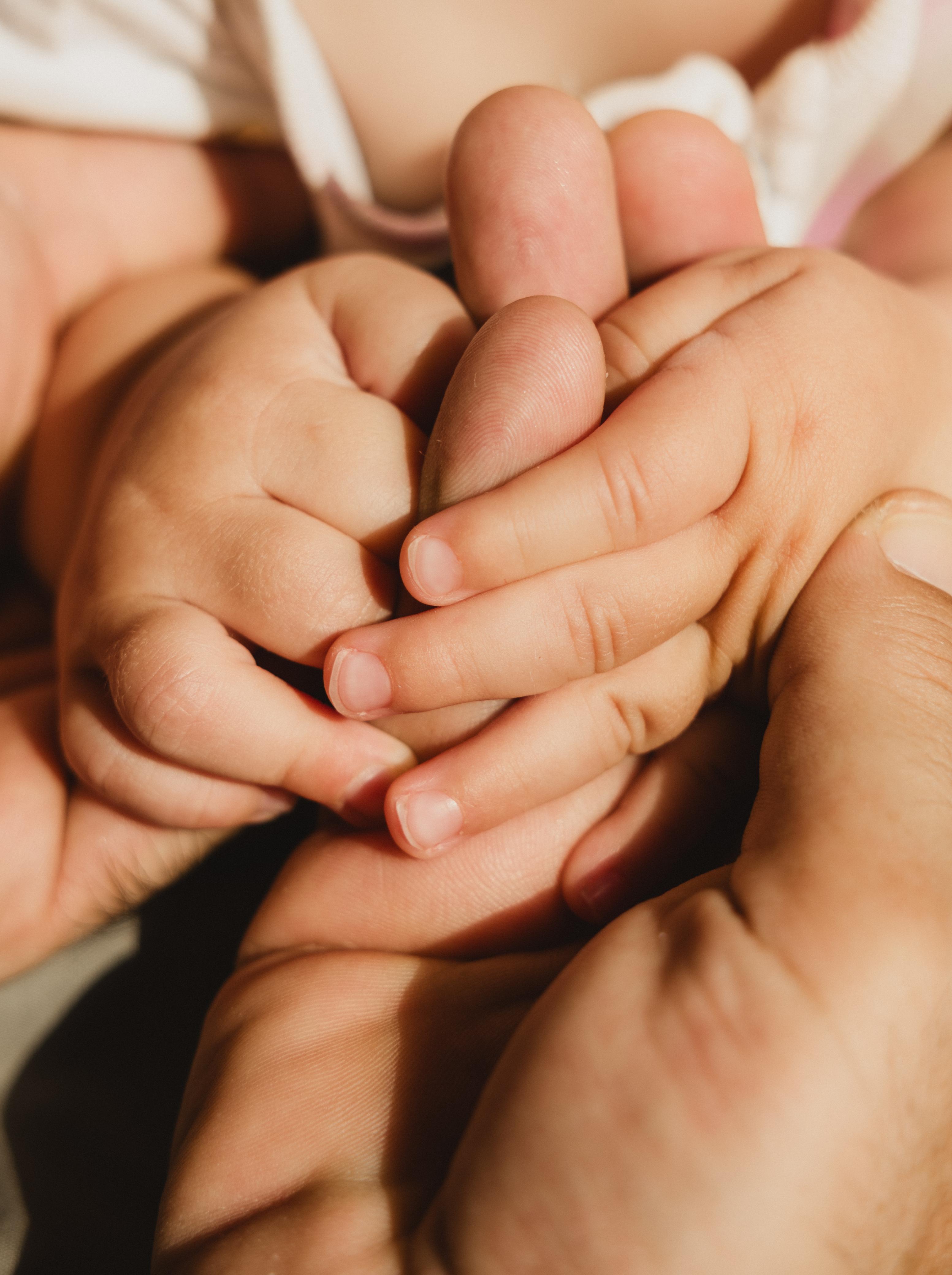 Family Hands Together – Newborns photography in Dubai by Elina K.
