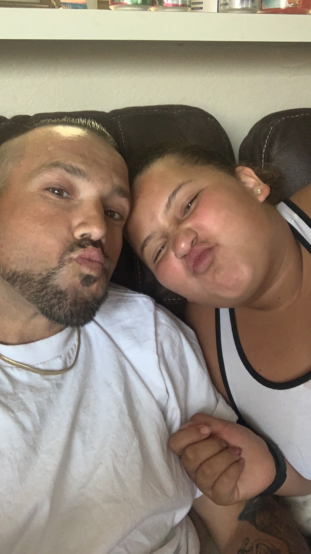 Kevin and Zyann taking an outdoor selfie under a blue sky