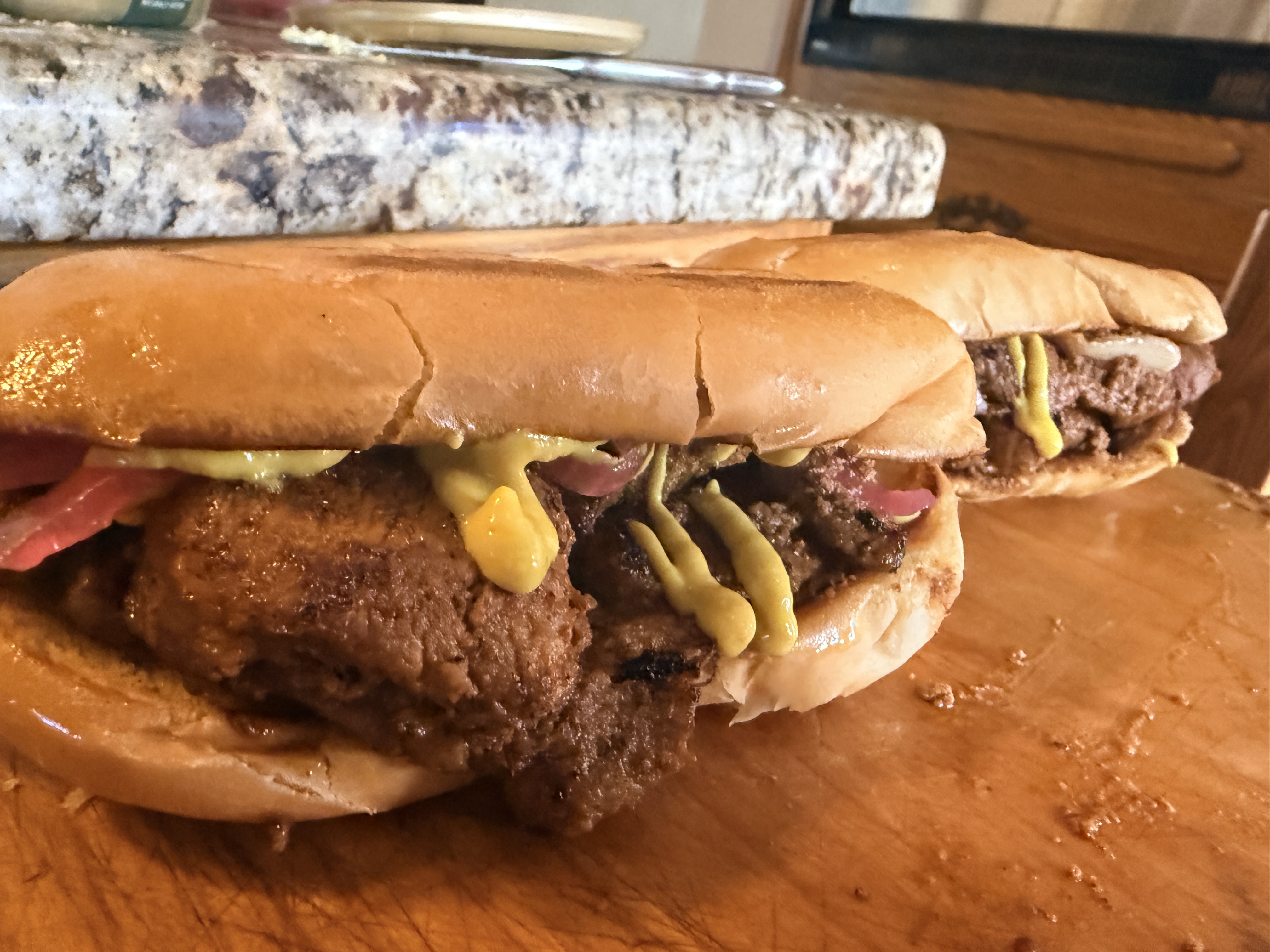Bifana — Marinated pork cutlets, slow-stewed in garlic, white wine and paprika, tucked into a crusty Portuguese papo-seco roll.