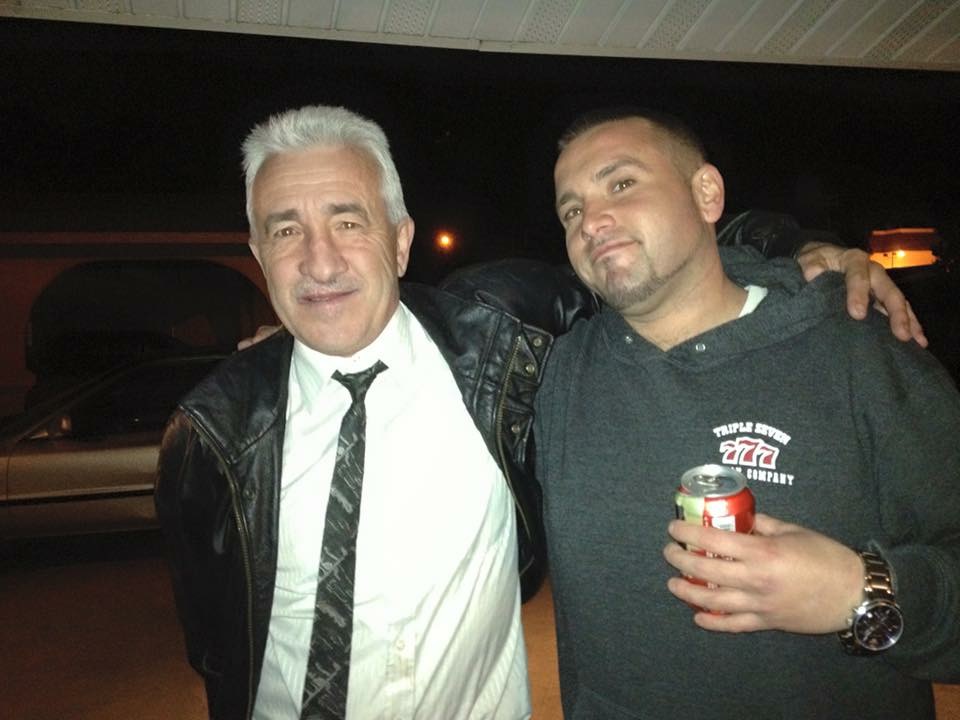 Jorge Fonseca with his son Kevin, arms around each other at an evening event
