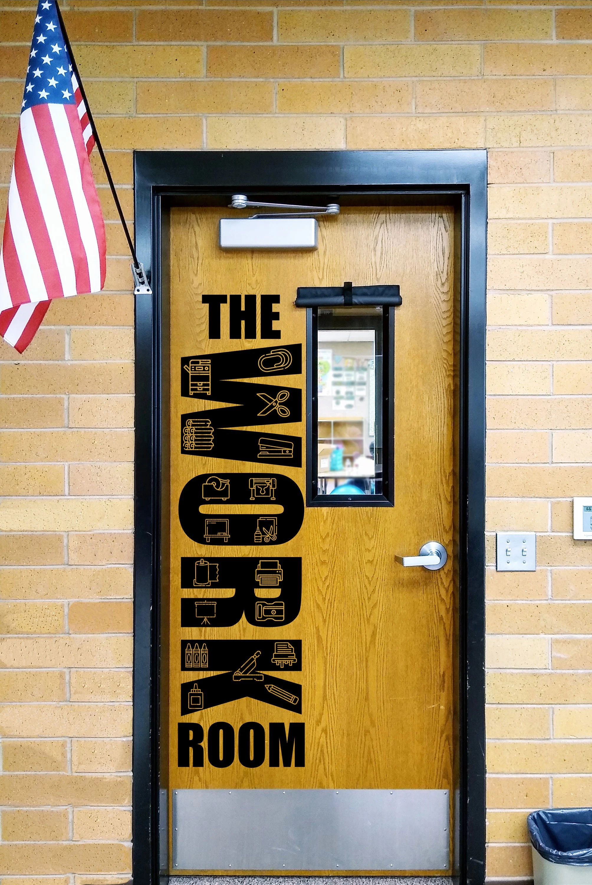 School door wrapped in custom-cut vinyl: 'The Work Room' decal with icons
