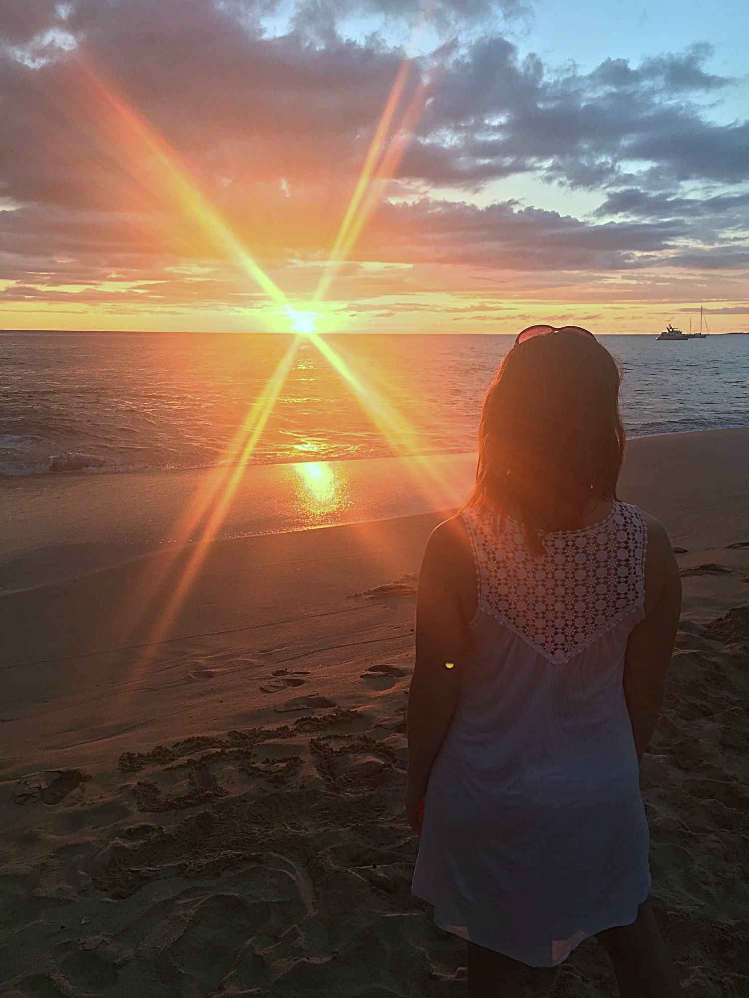 Woman watching a golden sunrise over the ocean — a moment of stillness and trust