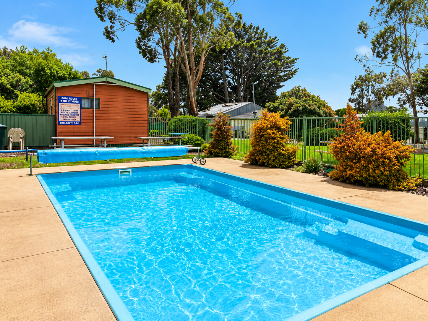 Outdoor swimming pool with surrounding deck at Shady Acres