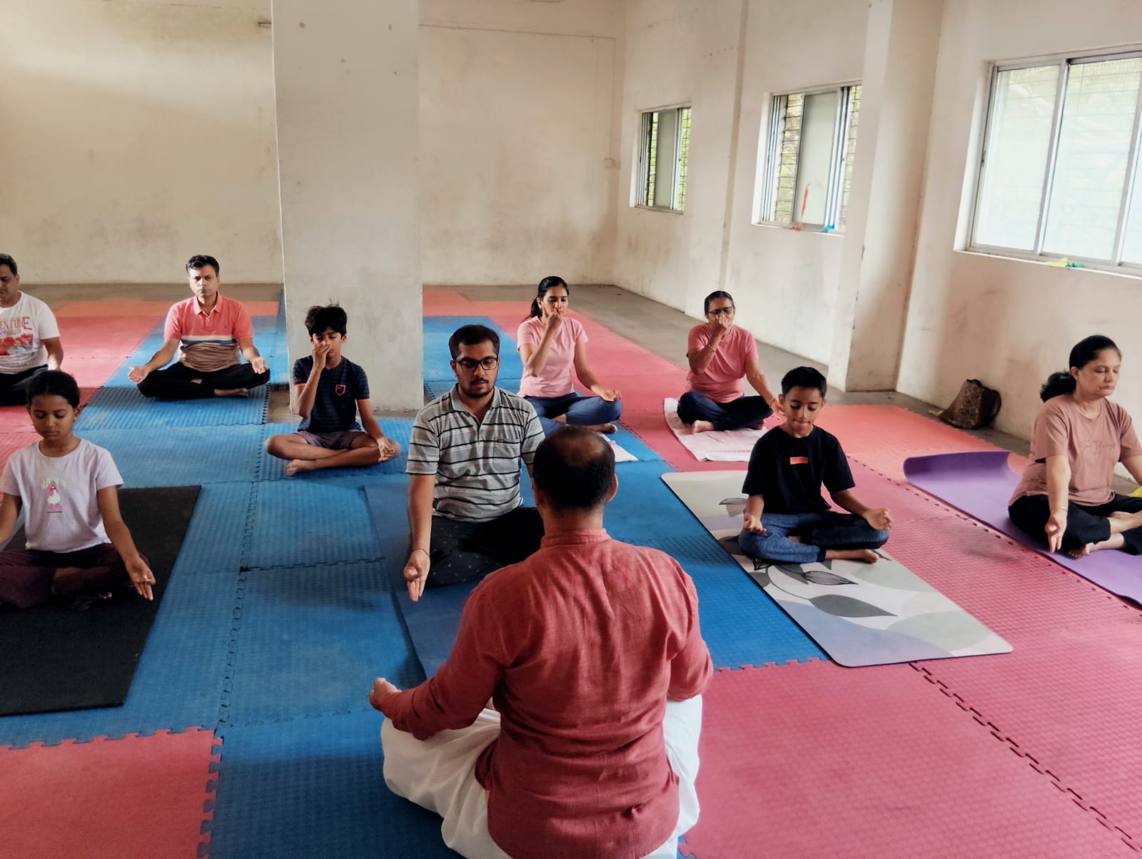 Sunlit yoga studio with practitioners