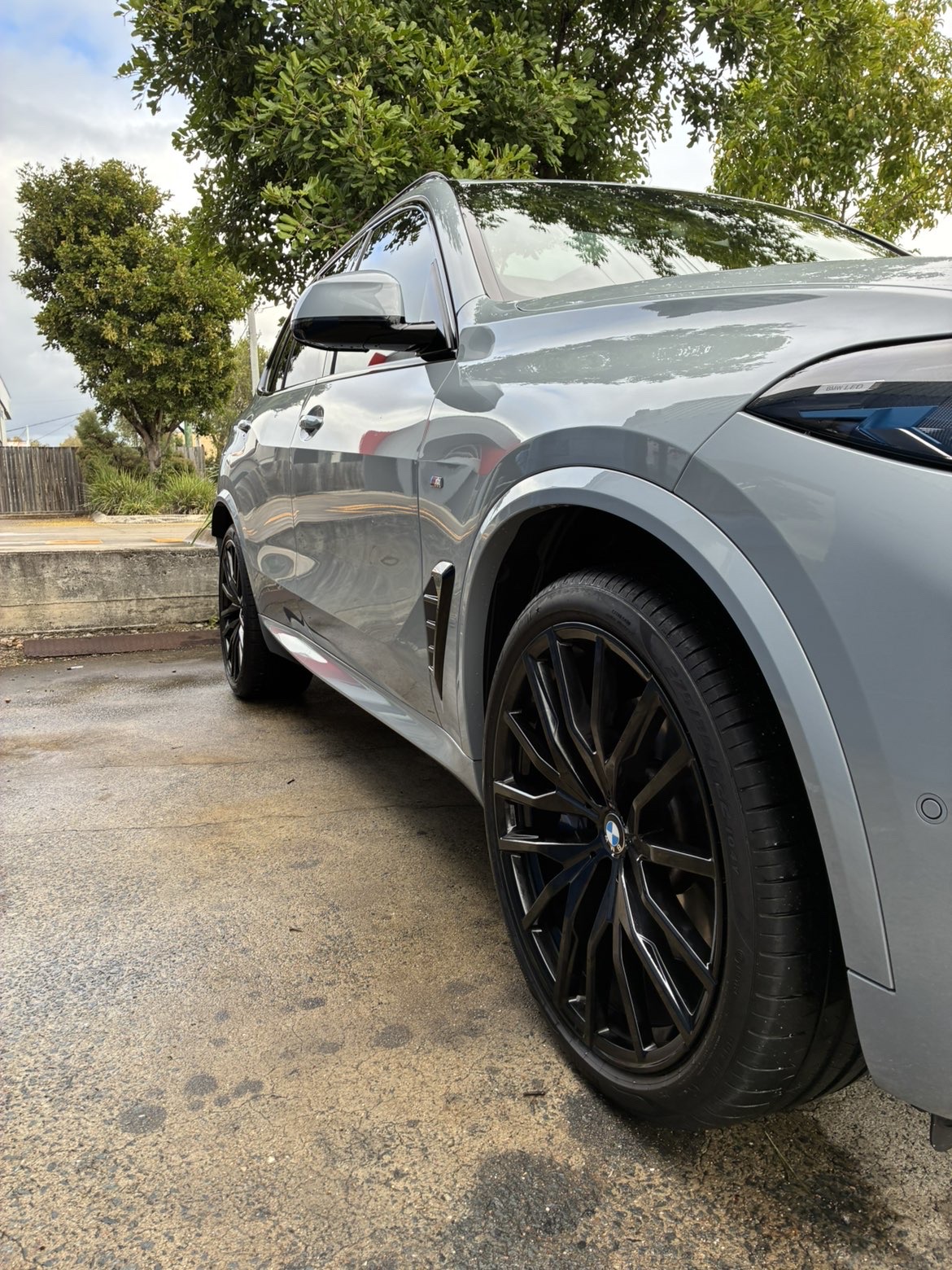 BMW X5 wheel and front quarter — showroom finish