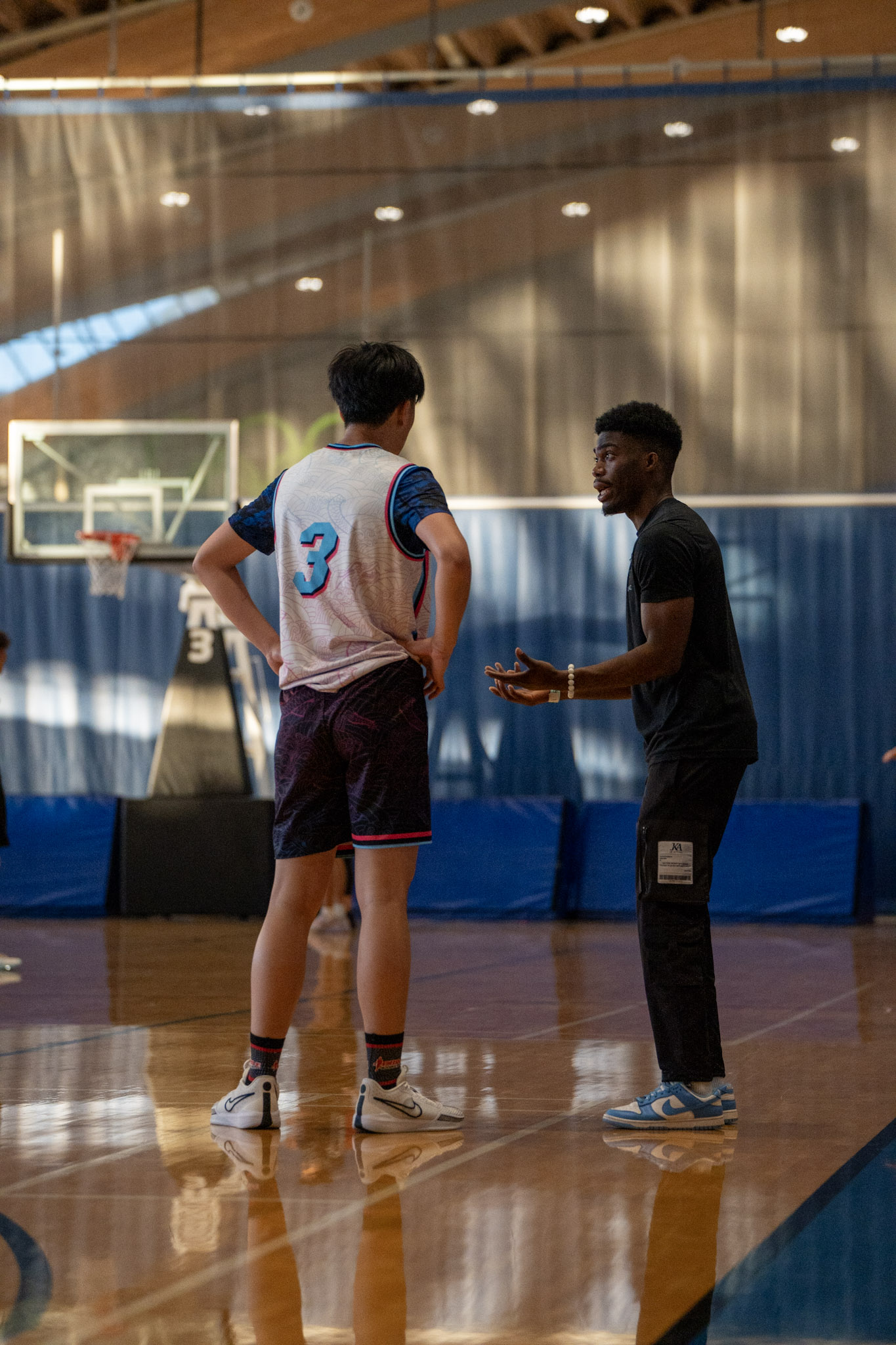 Coach mentoring a young player