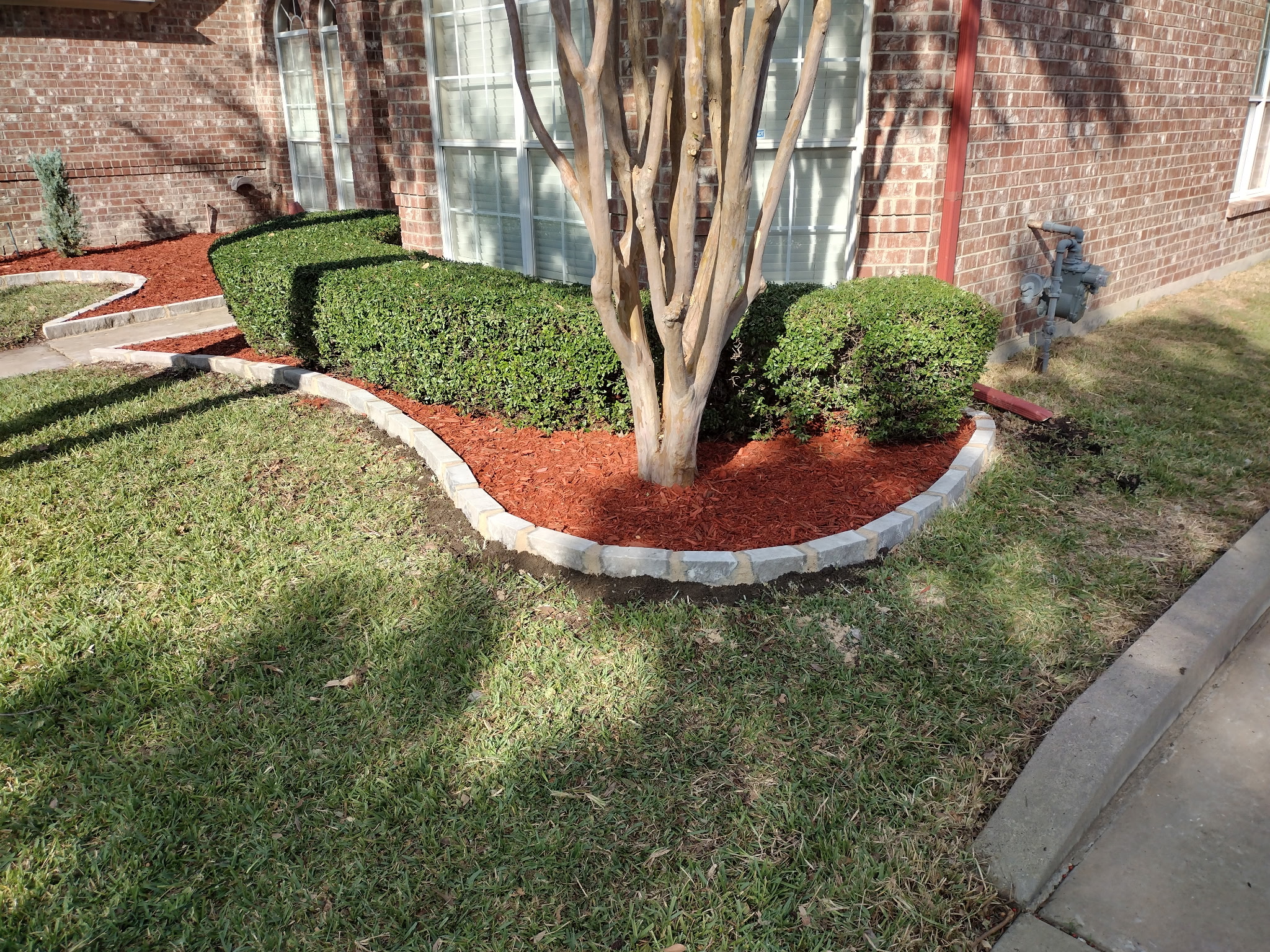 Professional landscaping with mulch bed Kansas City