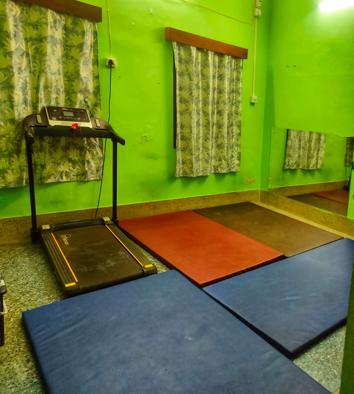 Exercise and movement therapy room with treadmill