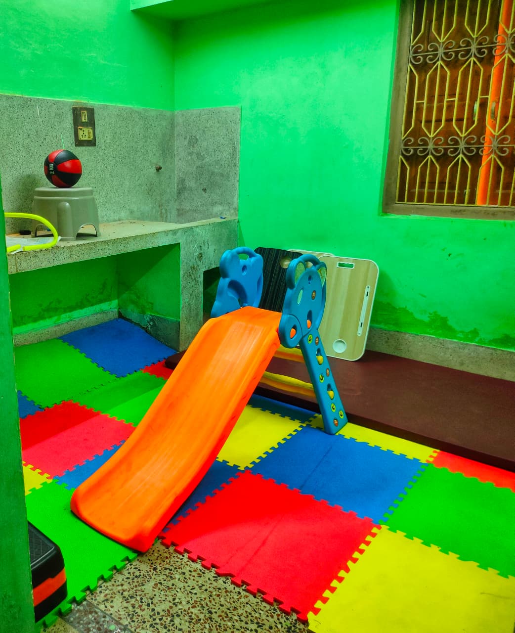 Indoor play room with slide and foam mats