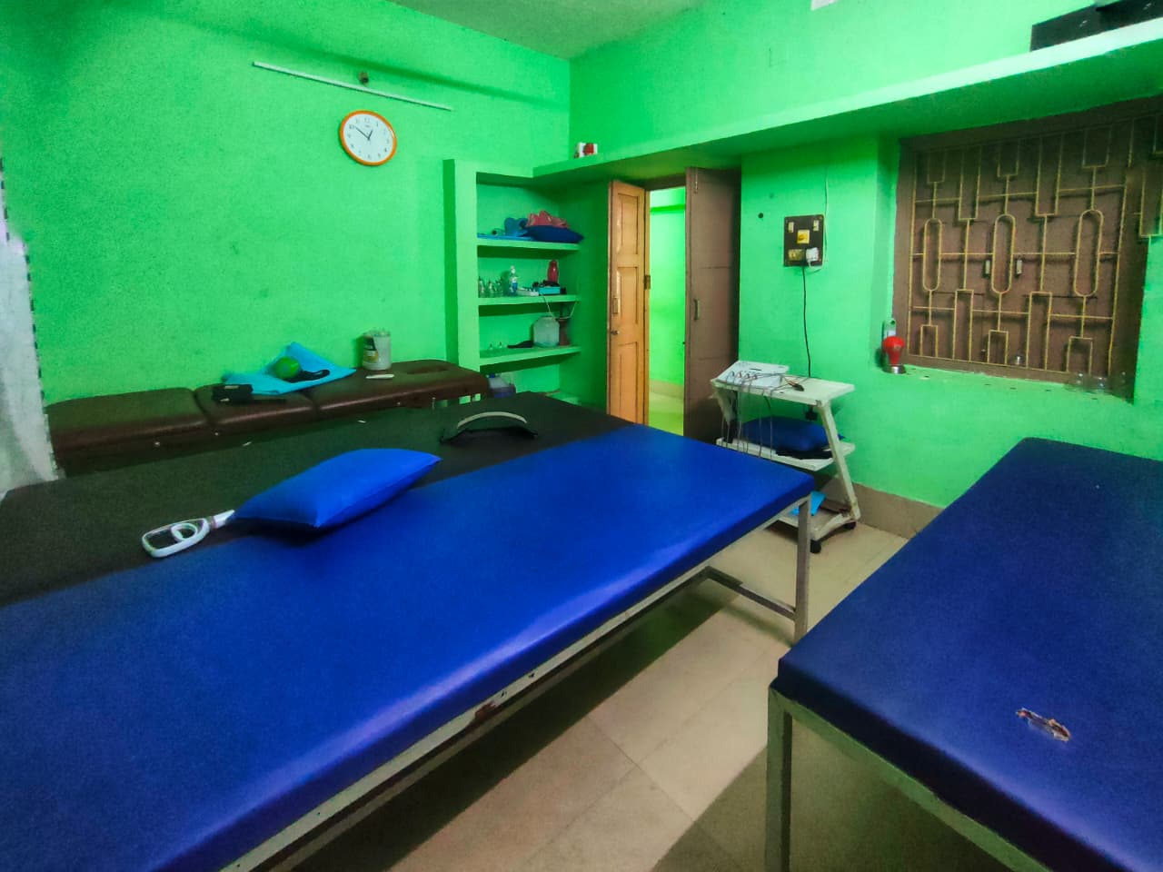 Well-equipped physiotherapy room with blue beds