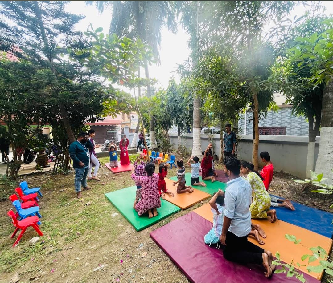 Outdoor group exercise session with children on colourful mats