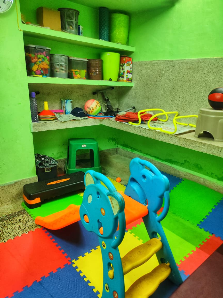 Activity room with toys, shelves and play equipment