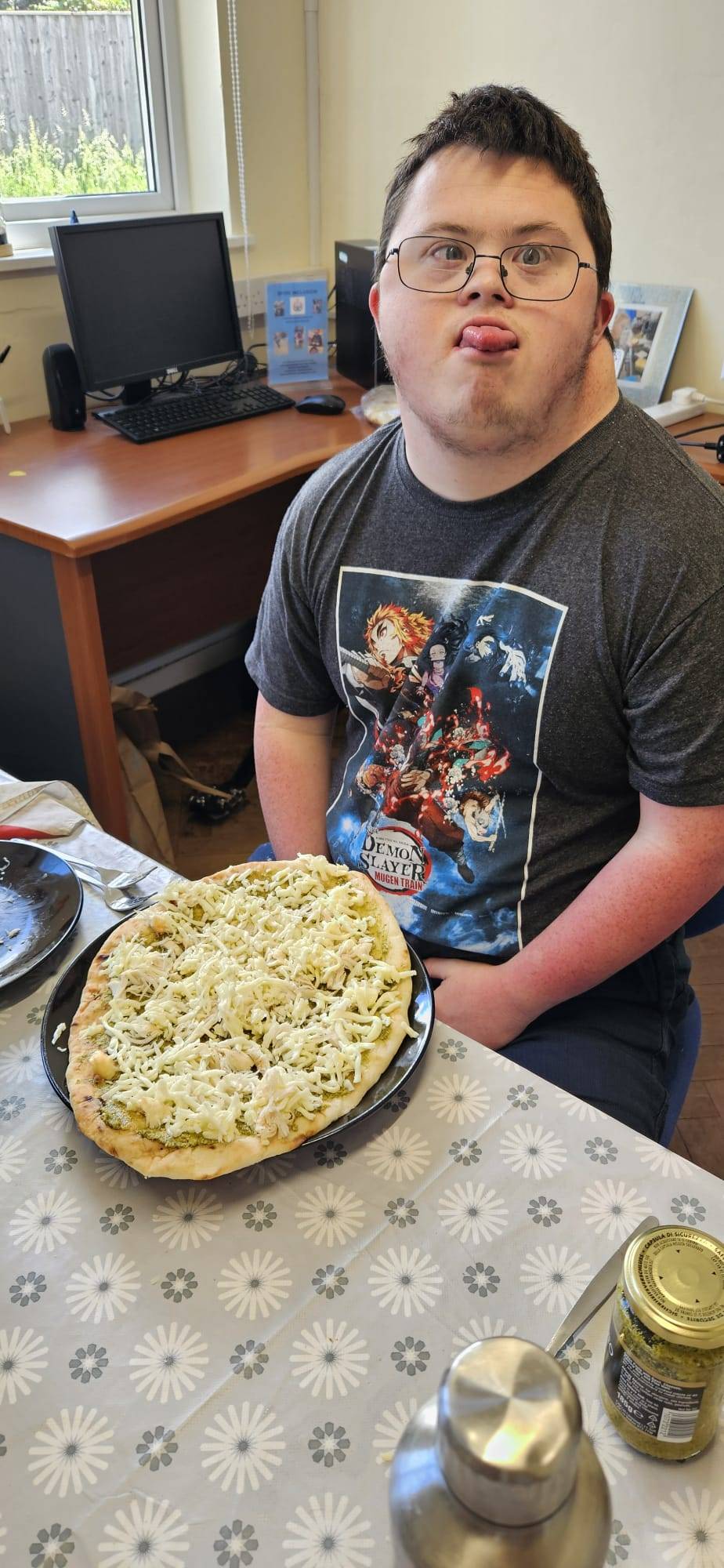 Someone we support spooning flapjack mixture into a baking tin during a cooking session.