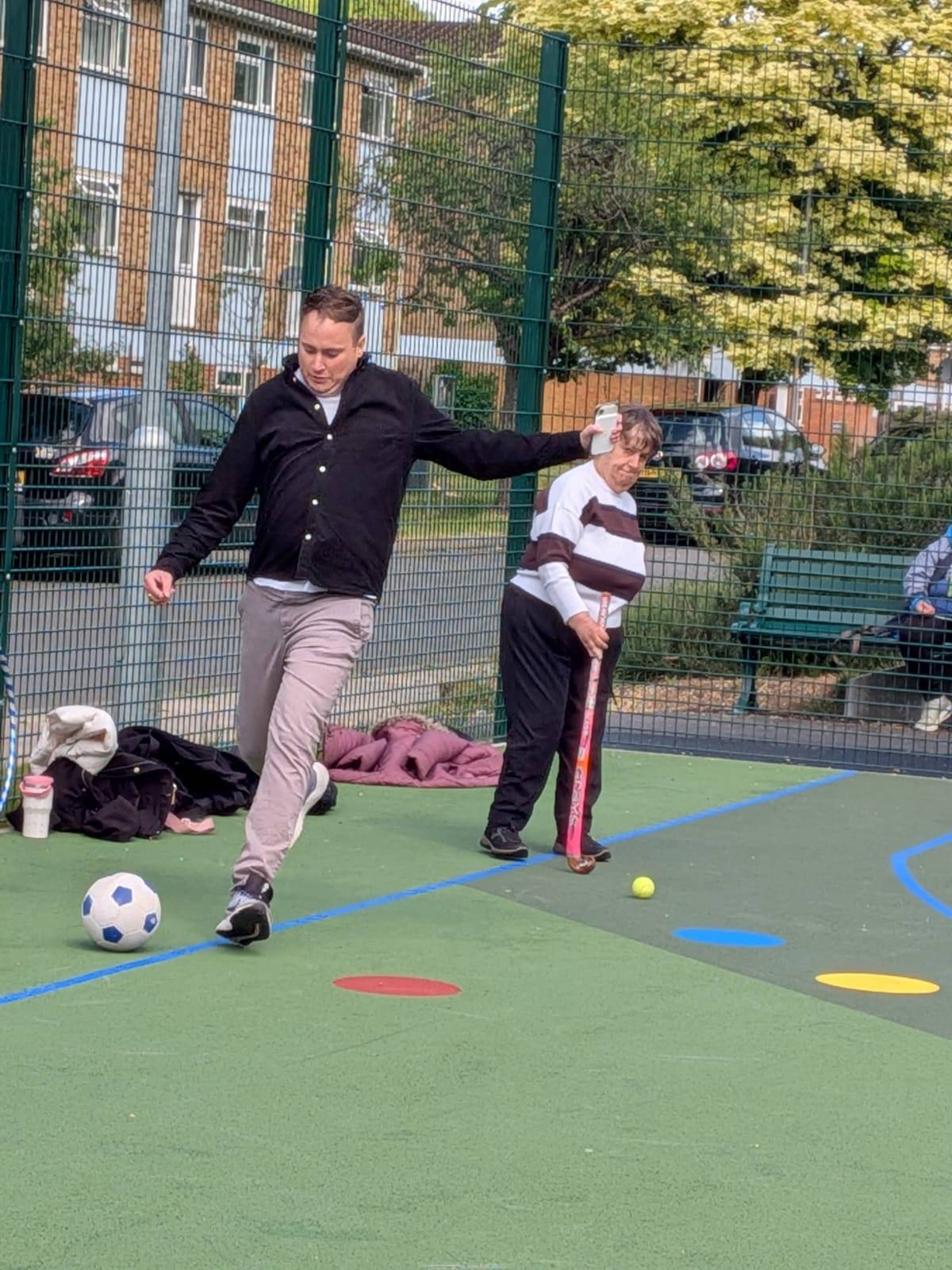 Someone we support playing a lively ball game on an outdoor court.