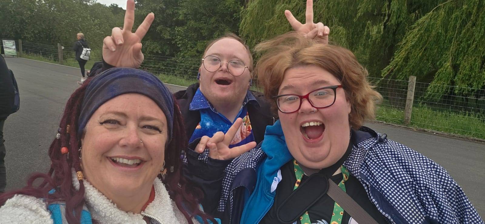 A happy group of people we support smiling together on a day out.