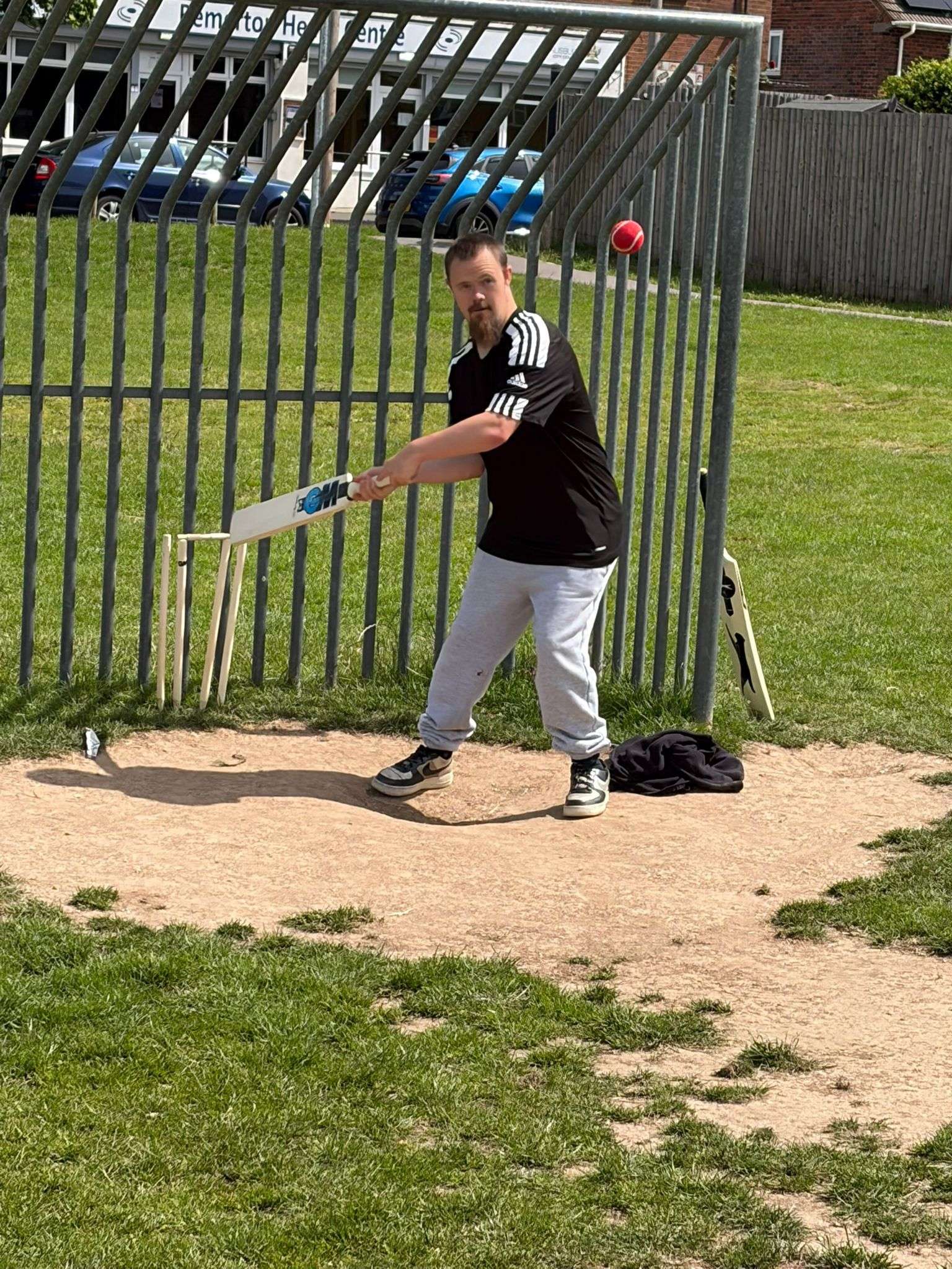 Someone we support batting during a game of cricket on a sunny field.
