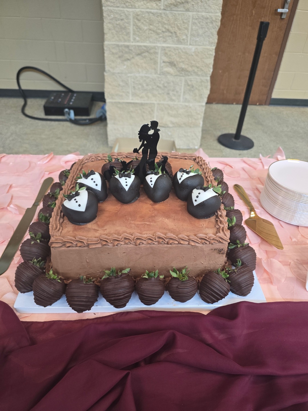Chocolate groom’s cake with tuxedo-dipped chocolate strawberries and wedding couple silhouette topper
