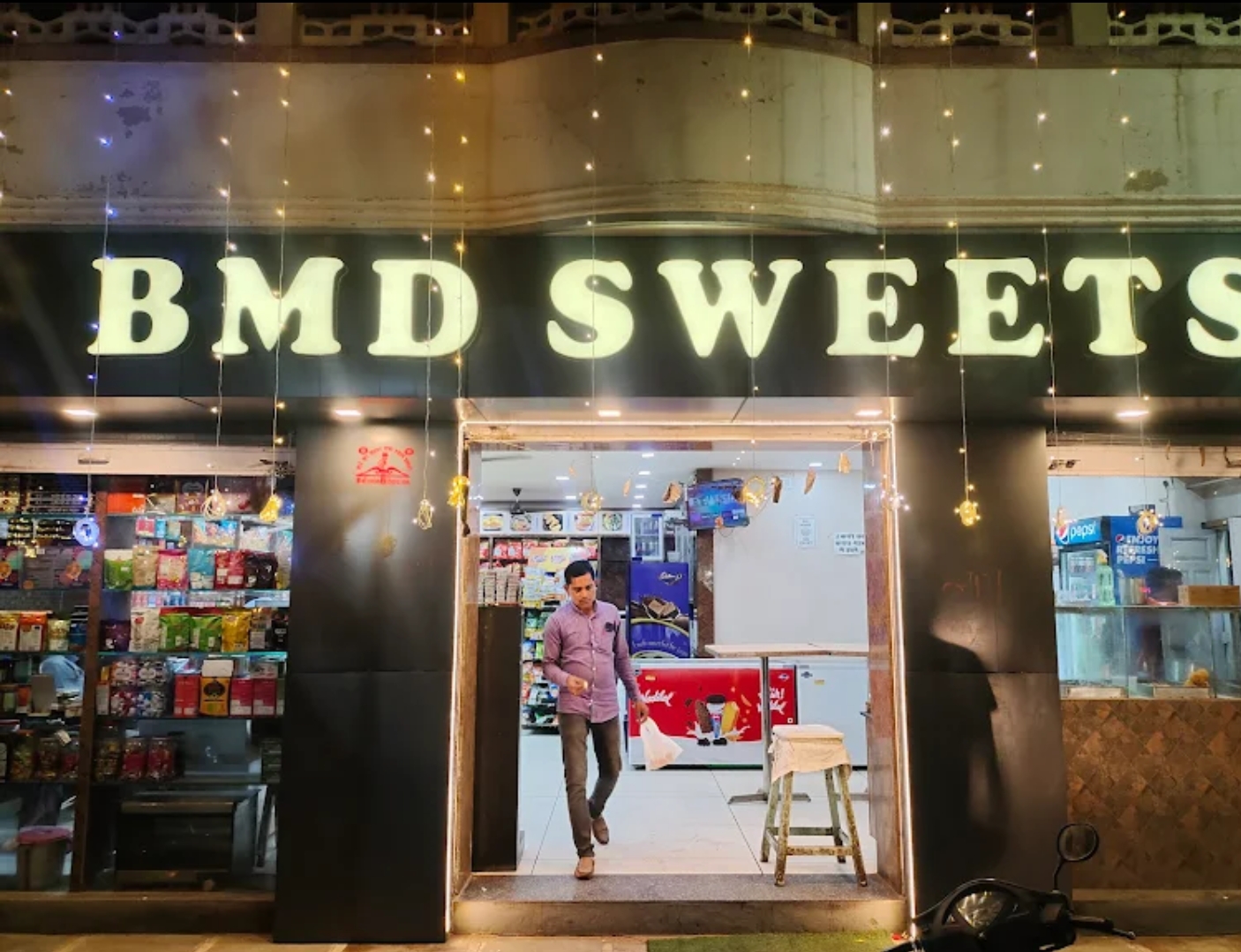 BMD Sweets storefront at night