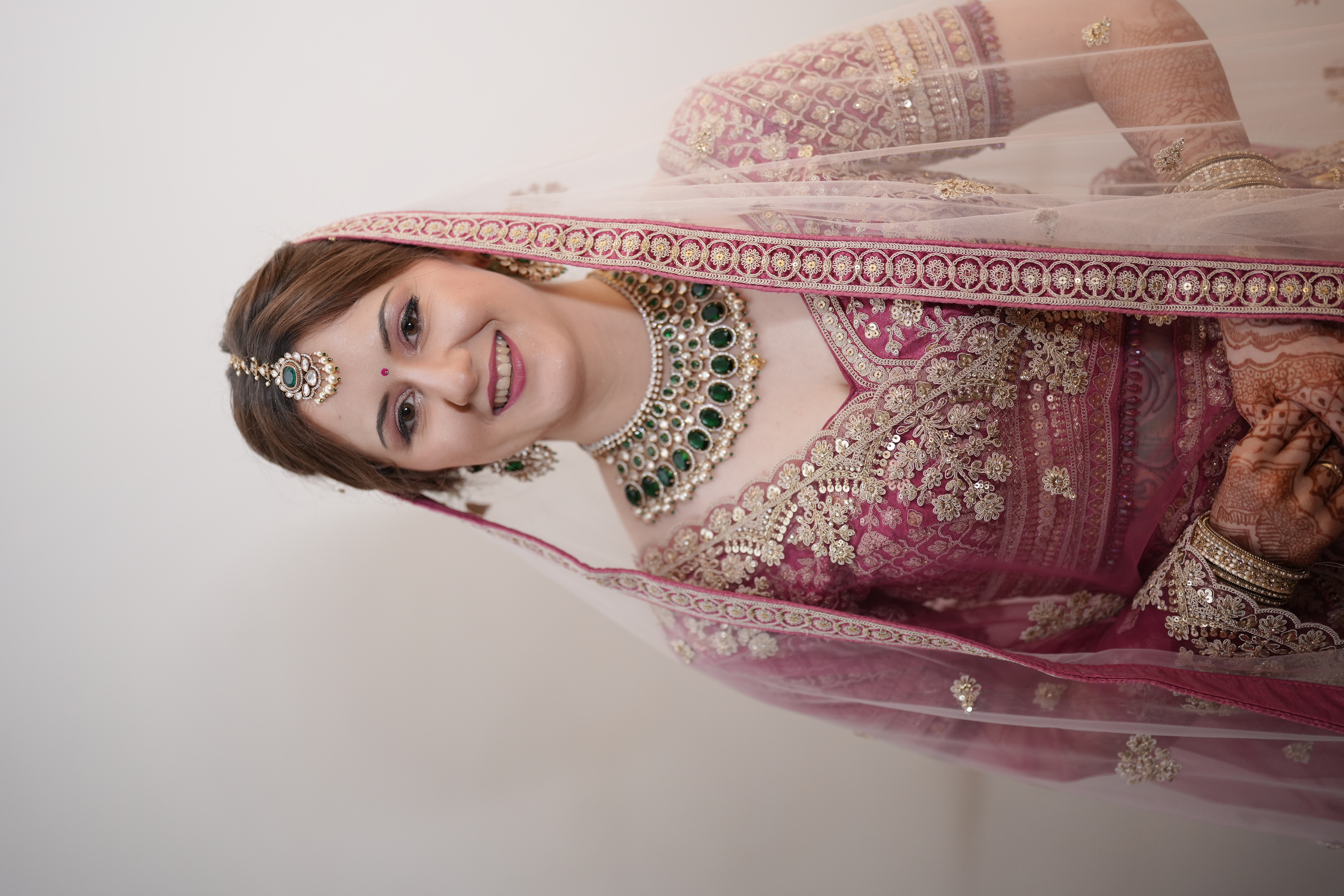 German bride full reception portrait — emerald kundan necklace, magenta lehenga, bridal mehendi hands — La Helen's Femme Coimbatore