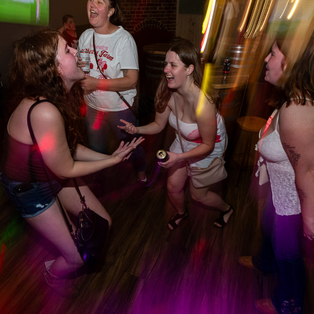 Crew on the dance floor singing