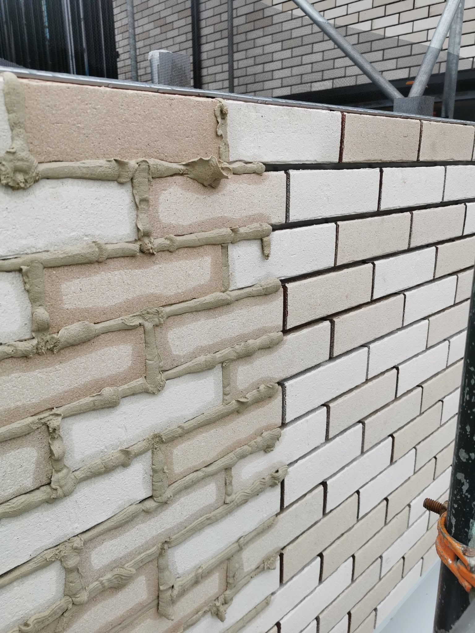 Prefabricated brick-slip cladding panels prepared on site, ready for installation on the support rail system