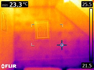 Living room internal wall — cold spot behind framed picture indicating localised cold-bridging where heat is conducted through the structure