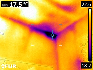 Calibrated blower door fan installed in the front doorway, sealed with the red airtight panel — ready to depressurise the property for airtightness testing