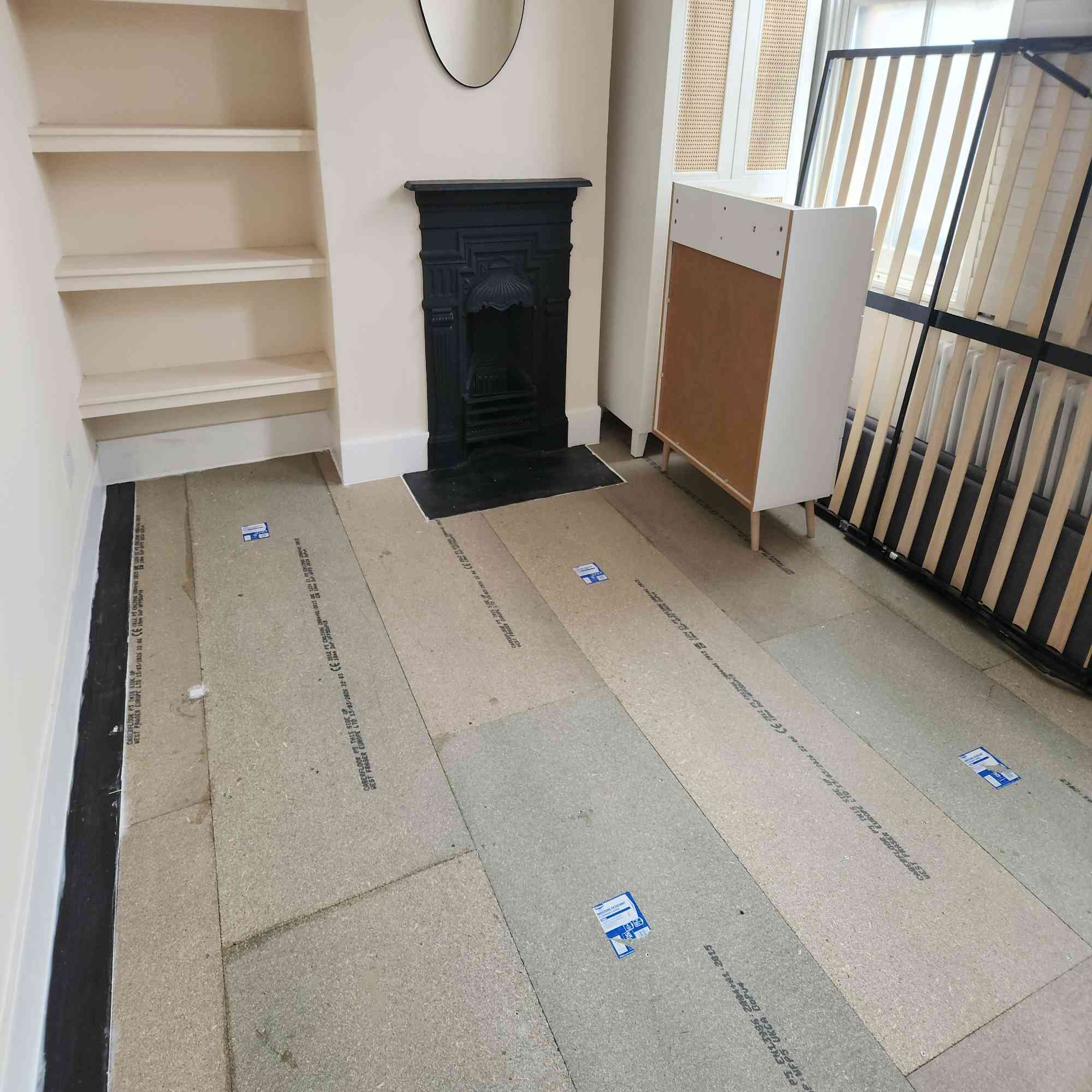 Stage 4 — finished decoupled floor build-up with moisture-resistant acoustic boards (RW5 system) ready for floor finish — significant airborne and impact noise reduction achieved