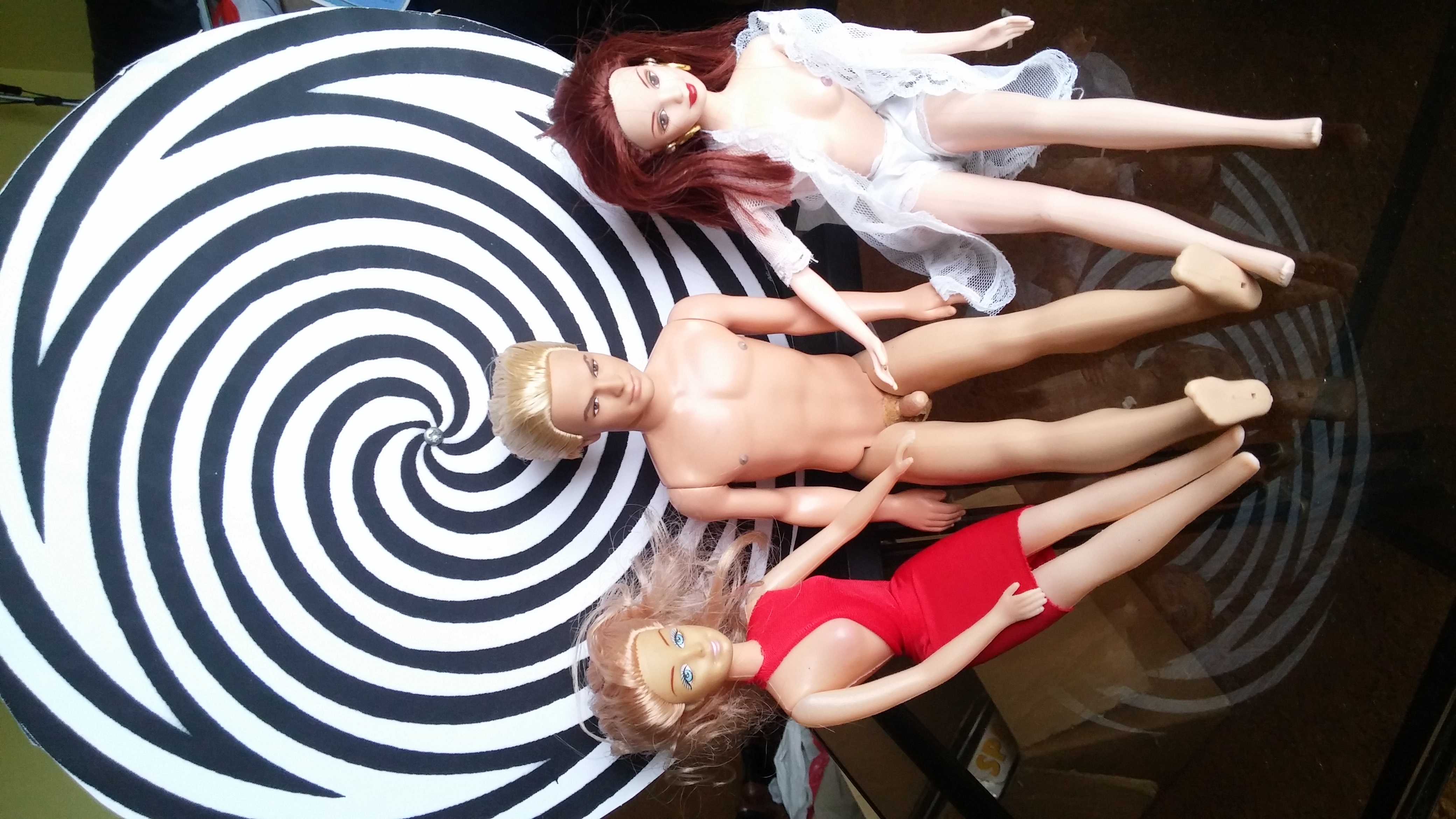 Dolls arranged before a hypnotic spiral - emblem of the practice