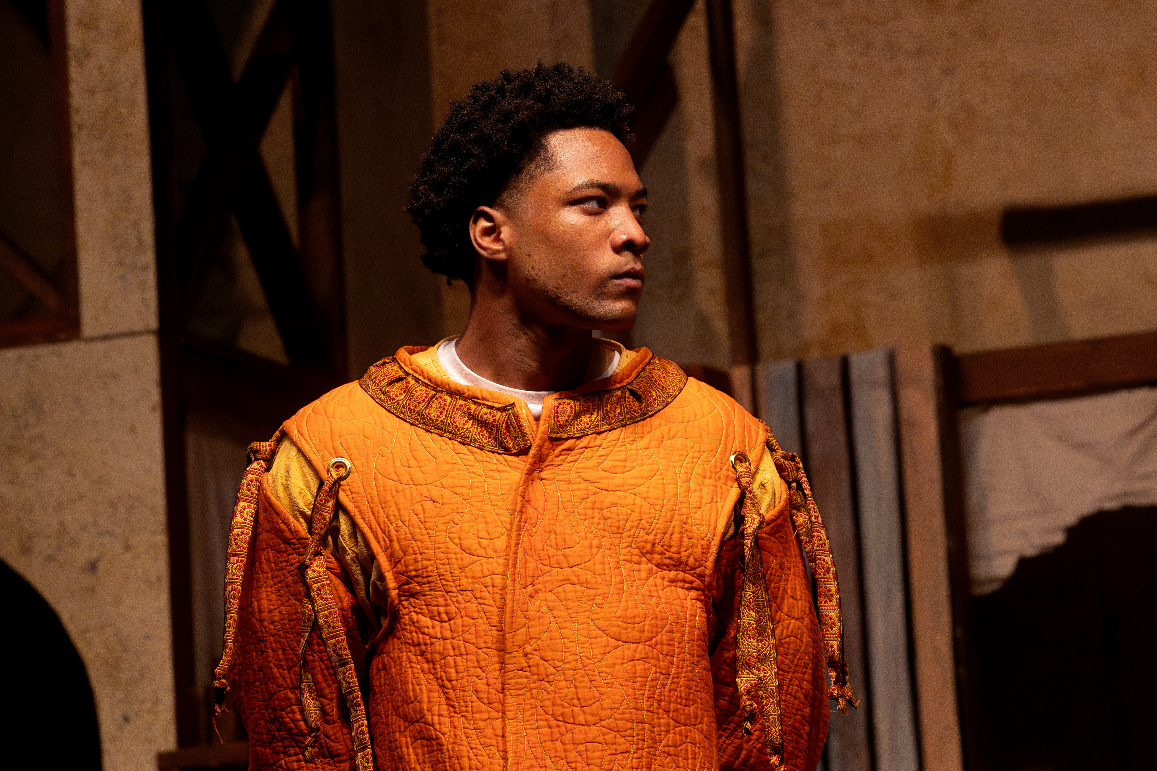 Henry IV portrait in orange costume on Shakespeare stage