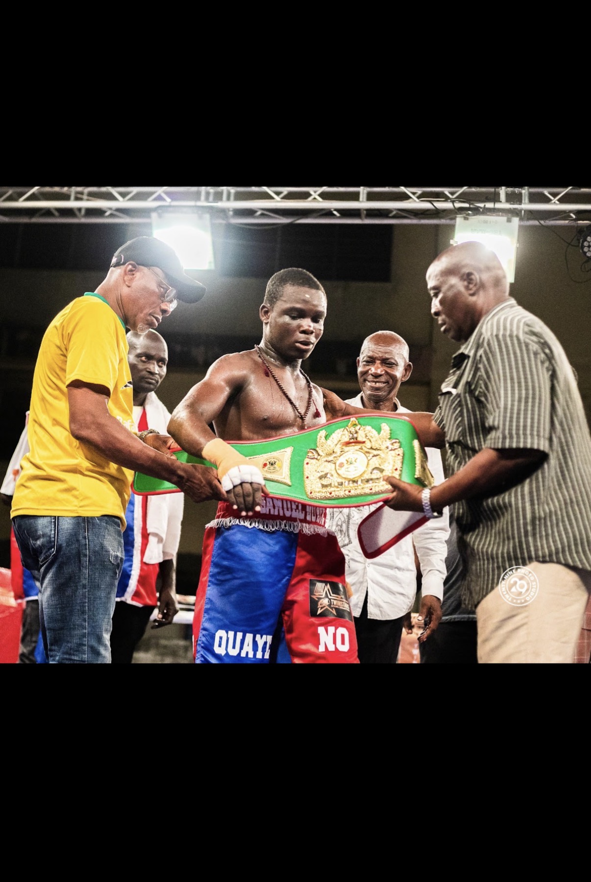 Belt up — the new champion with his cornermen.